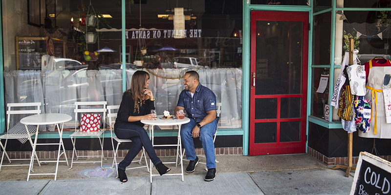 Couple sitting at a table in front of a shop in Downtown Overland Park
